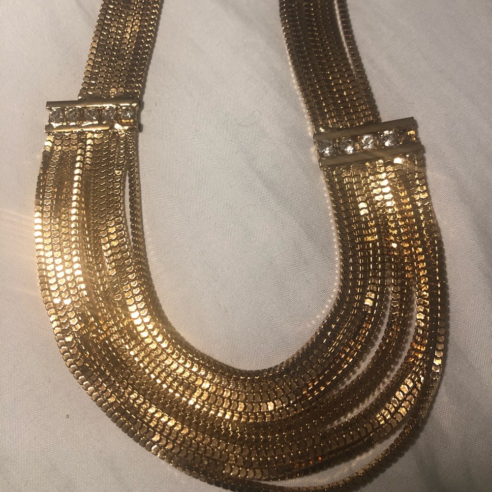 Gold colored necklace with stones